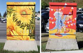 Utility Boxes that have sun flowers that are painted